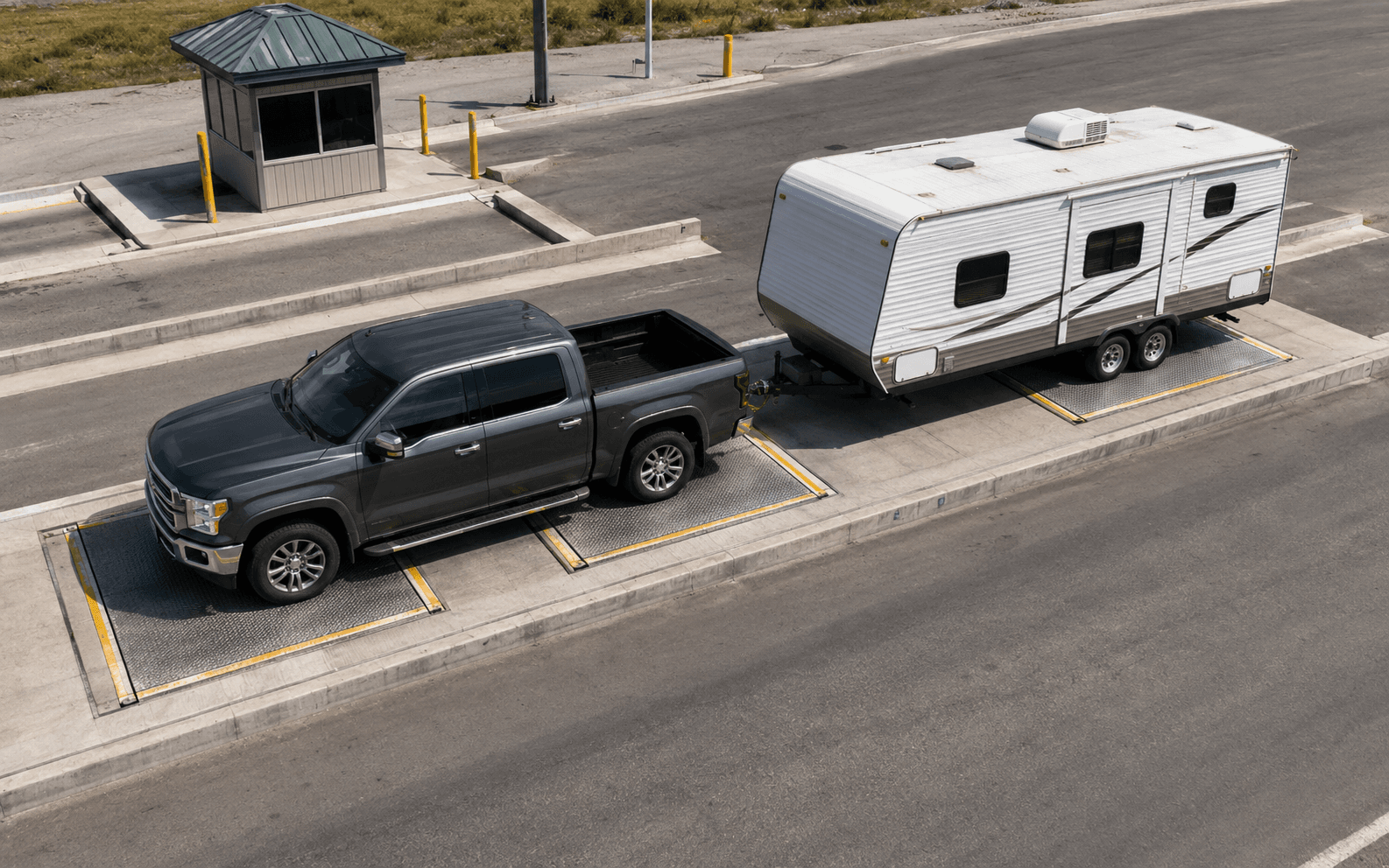 Truck and travel trailer positioned across three scale platforms