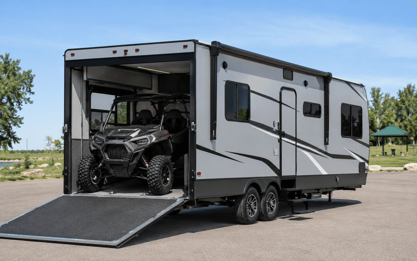 Side-by-side utility vehicle loaded inside a toy-hauler trailer